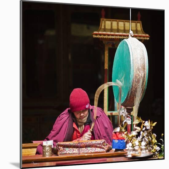India, Ladakh, Hemis, Monk Reciting Prayers to the Slow Rhythm of a Drum at Hemis Monastery-Katie Garrod-Mounted Photographic Print