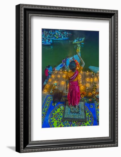 India, Varanasi Young Boy in Pink and Yellow Robes Holds Up an Offering to the Ganges River-Ellen Clark-Framed Photographic Print