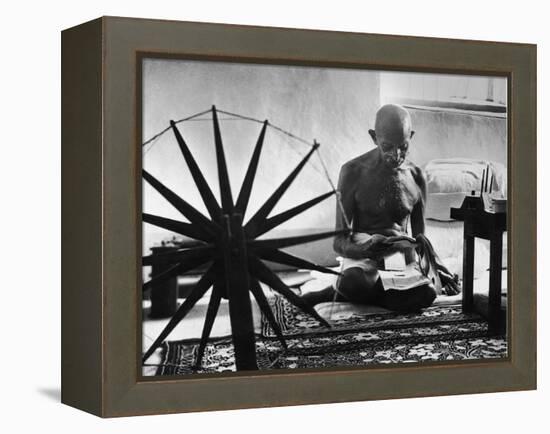 Indian Leader Mohandas Gandhi Reading as He Sits Cross Legged on Floor-Margaret Bourke-White-Framed Premier Image Canvas