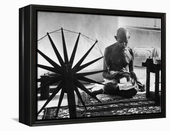 Indian Leader Mohandas Gandhi Reading as He Sits Cross Legged on Floor-Margaret Bourke-White-Framed Premier Image Canvas