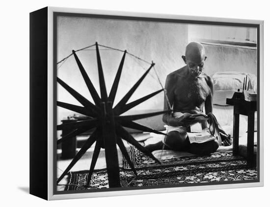 Indian Leader Mohandas Gandhi Reading as He Sits Cross Legged on Floor-Margaret Bourke-White-Framed Premier Image Canvas