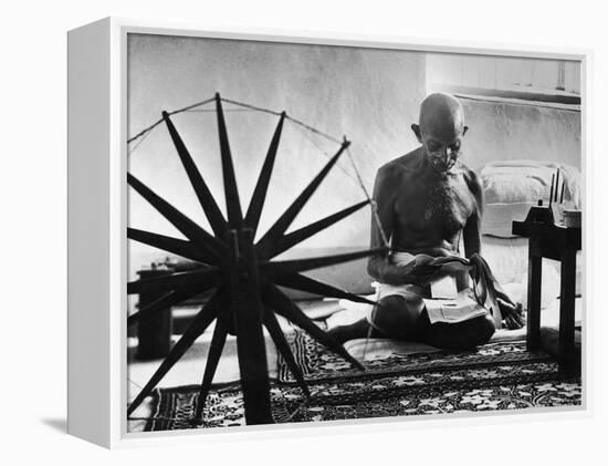 Indian Leader Mohandas Gandhi Reading as He Sits Cross Legged on Floor-Margaret Bourke-White-Framed Premier Image Canvas