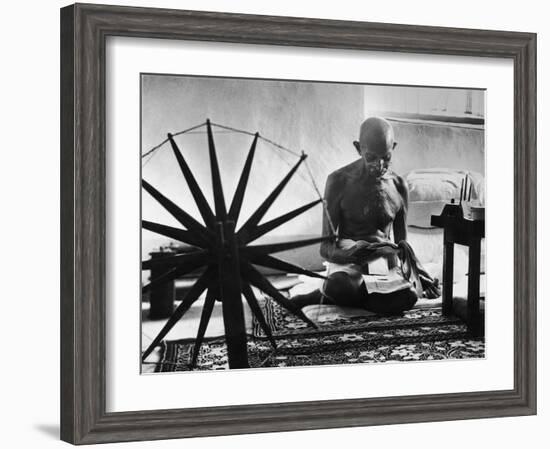 Indian Leader Mohandas Gandhi Reading as He Sits Cross Legged on Floor-Margaret Bourke-White-Framed Premium Photographic Print