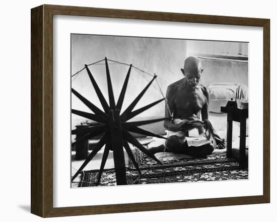 Indian Leader Mohandas Gandhi Reading as He Sits Cross Legged on Floor-Margaret Bourke-White-Framed Premium Photographic Print