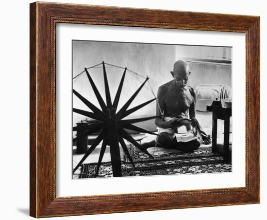 Indian Leader Mohandas Gandhi Reading as He Sits Cross Legged on Floor-Margaret Bourke-White-Framed Premium Photographic Print