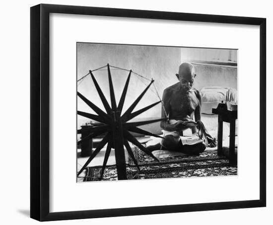 Indian Leader Mohandas Gandhi Reading as He Sits Cross Legged on Floor-Margaret Bourke-White-Framed Premium Photographic Print