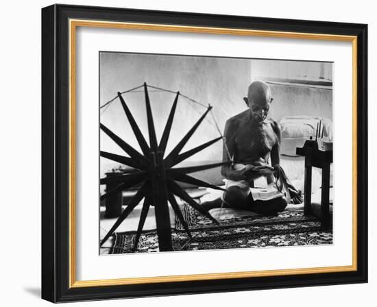 Indian Leader Mohandas Gandhi Reading as He Sits Cross Legged on Floor-Margaret Bourke-White-Framed Premium Photographic Print