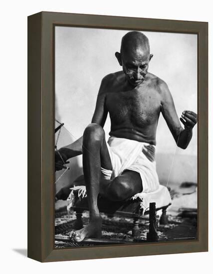 Indian Leader Mohandas Gandhi Using His Spinning Wheel in Bungalow at His Nature Clinic-Margaret Bourke-White-Framed Premier Image Canvas