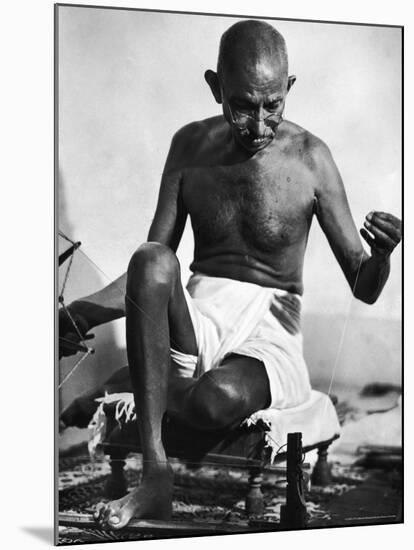 Indian Leader Mohandas Gandhi Using His Spinning Wheel in Bungalow at His Nature Clinic-Margaret Bourke-White-Mounted Premium Photographic Print