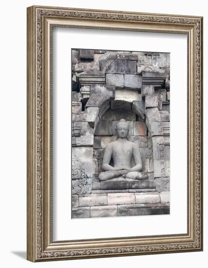Indonesia, Java, Borobudur. Largest Buddhist monument in the world. Buddha statue in ornate wall.-Cindy Miller Hopkins-Framed Photographic Print
