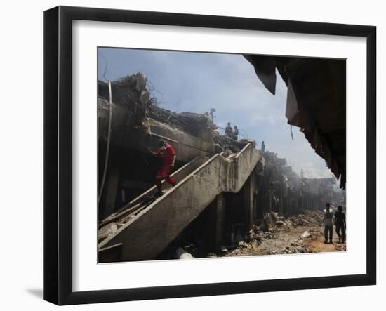 Indonesian Rescue Workers Walk on a Eartquake Damaged Building, in Padang, Indonesia-null-Framed Photographic Print