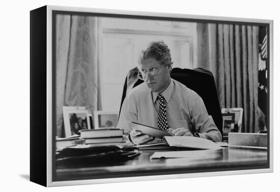 Informal Portrait of President Bill Clinton at His Desk in the Oval Office-null-Framed Stretched Canvas