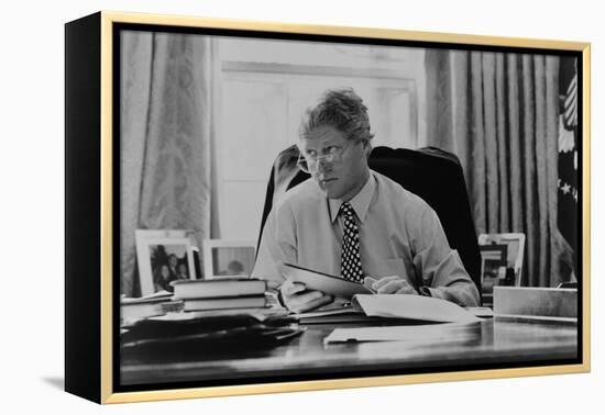 Informal Portrait of President Bill Clinton at His Desk in the Oval Office-null-Framed Stretched Canvas