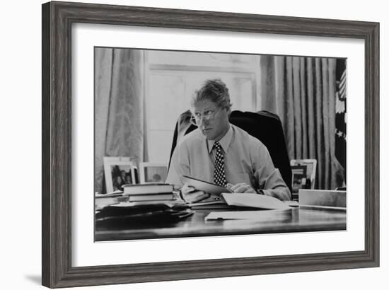 Informal Portrait of President Bill Clinton at His Desk in the Oval Office-null-Framed Photo