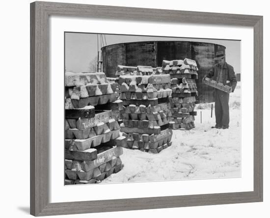 Ingot of Magnesium, Part of the U.S. Strategic Materials Stockpile, Stacked and Covered with Snow-Ed Clark-Framed Premium Photographic Print