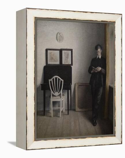 Interior with a young man reading, 1898-Vilhelm Hammershoi-Framed Premier Image Canvas