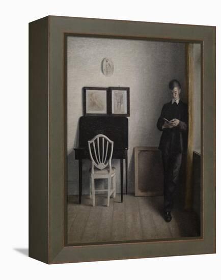 Interior with a young man reading, 1898-Vilhelm Hammershoi-Framed Premier Image Canvas