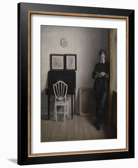 Interior with a young man reading, 1898-Vilhelm Hammershoi-Framed Giclee Print