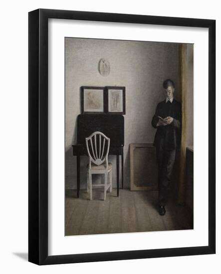 Interior with a young man reading, 1898-Vilhelm Hammershoi-Framed Giclee Print