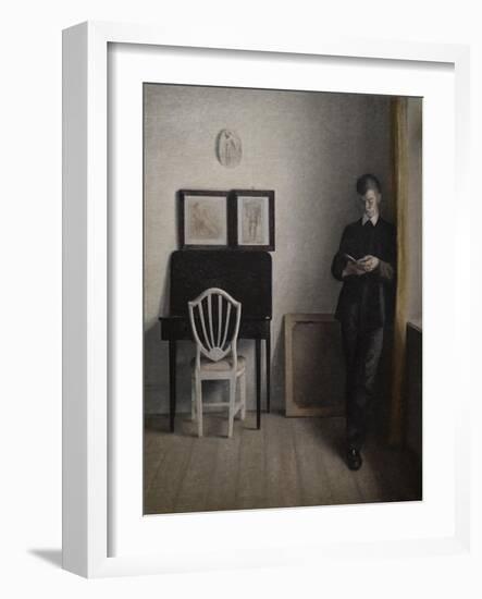 Interior with a young man reading, 1898-Vilhelm Hammershoi-Framed Giclee Print