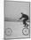 Inventor Maurice Steinlauf Riding Eccentric Bike with Roving Front Wheel-Wallace Kirkland-Mounted Photographic Print