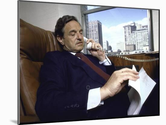 Investment Banker George Soros Working on Phone in Office-null-Mounted Photographic Print