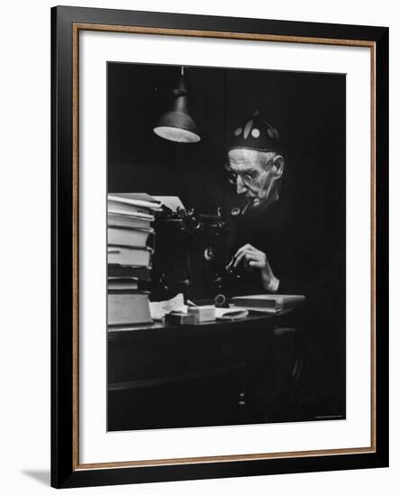 Irish Playwright Sean O'Casey with Pipe in His Mouth as He Works at His Typewriter at Home-Gjon Mili-Framed Premium Photographic Print