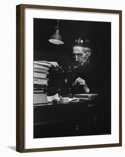 Irish Playwright Sean O'Casey with Pipe in His Mouth as He Works at His Typewriter at Home-Gjon Mili-Framed Premium Photographic Print