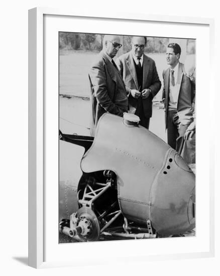 Italian Enzo Ferrari (Left), Looks over a 1959 Racing Car with Technicians-null-Framed Photo