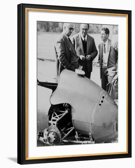 Italian Enzo Ferrari (Left), Looks over a 1959 Racing Car with Technicians-null-Framed Photo