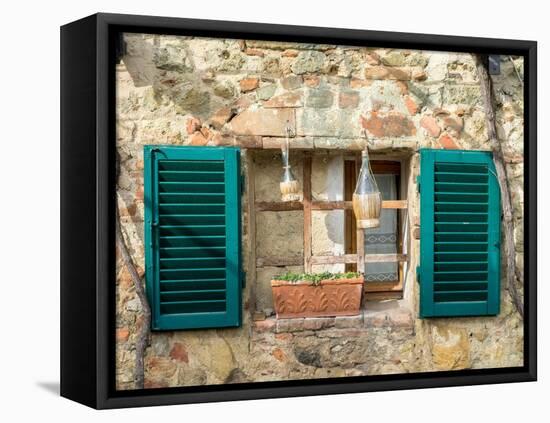 Italy, Chianti, Monteriggioni. Barred window with shutters, wine bottles and planter.-Julie Eggers-Framed Premier Image Canvas