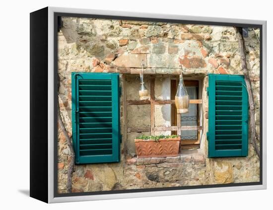 Italy, Chianti, Monteriggioni. Barred window with shutters, wine bottles and planter.-Julie Eggers-Framed Premier Image Canvas