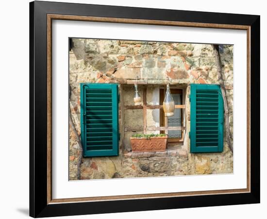 Italy, Chianti, Monteriggioni. Barred window with shutters, wine bottles and planter.-Julie Eggers-Framed Photographic Print