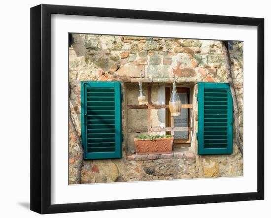 Italy, Chianti, Monteriggioni. Barred window with shutters, wine bottles and planter.-Julie Eggers-Framed Photographic Print