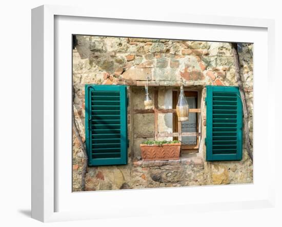 Italy, Chianti, Monteriggioni. Barred window with shutters, wine bottles and planter.-Julie Eggers-Framed Photographic Print