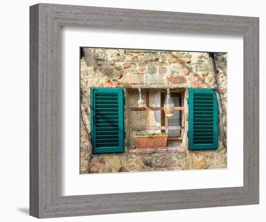 Italy, Chianti, Monteriggioni. Barred window with shutters, wine bottles and planter.-Julie Eggers-Framed Photographic Print