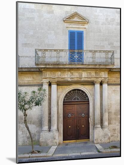 Italy, Puglia, Brindisi, Itria Valley, Ostuni. Wooden door with balcony above and blue shutters.-Julie Eggers-Mounted Photographic Print