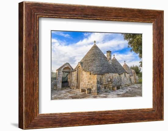 Italy, Region of Apulia, Province of Bari, Itria Valley, Alberobello. A trullo house-Emily Wilson-Framed Photographic Print