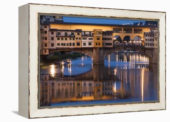 Italy, Tuscany, Florence, Ponte Vecchio reflected in Arno River at dusk.-Merrill Images-Framed Premier Image Canvas