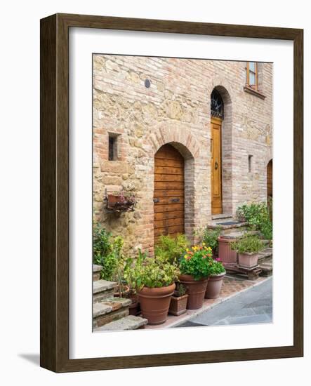 Italy, Tuscany, Pienza. Doorway surrounded by flowers.-Julie Eggers-Framed Photographic Print