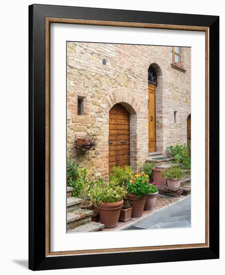 Italy, Tuscany, Pienza. Doorway surrounded by flowers.-Julie Eggers-Framed Photographic Print