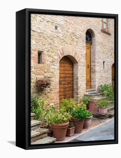 Italy, Tuscany, Pienza. Doorway surrounded by flowers.-Julie Eggers-Framed Premier Image Canvas