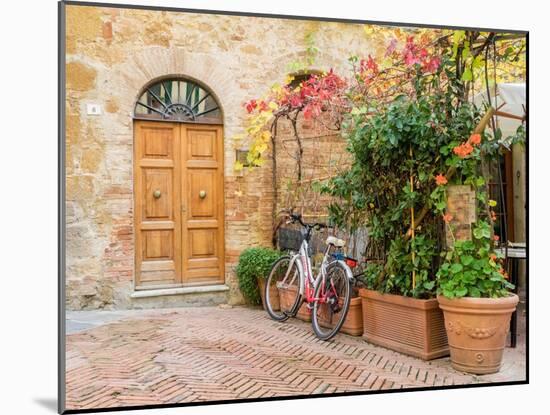 Italy, Tuscany, Pienza. Doorway surrounded by flowers.-Julie Eggers-Mounted Photographic Print