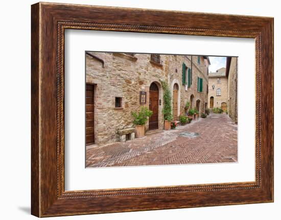 Italy, Tuscany, Pienza. Flower pots and potted plants decorate a narrow street in a Tuscany-Julie Eggers-Framed Photographic Print