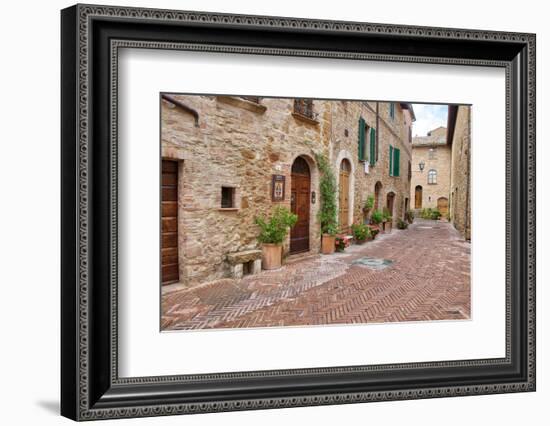 Italy, Tuscany, Pienza. Flower pots and potted plants decorate a narrow street in a Tuscany-Julie Eggers-Framed Photographic Print