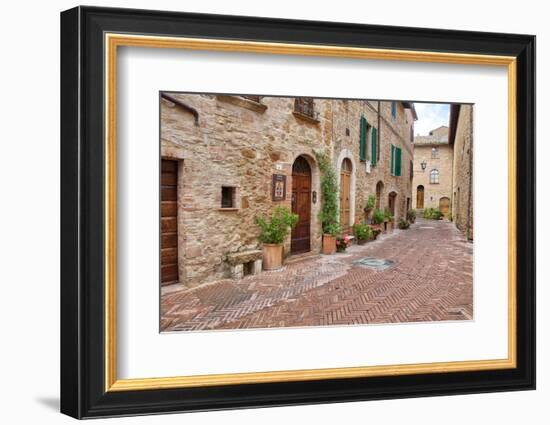 Italy, Tuscany, Pienza. Flower pots and potted plants decorate a narrow street in a Tuscany-Julie Eggers-Framed Photographic Print