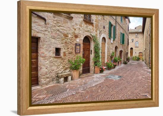 Italy, Tuscany, Pienza. Flower pots and potted plants decorate a narrow street in a Tuscany-Julie Eggers-Framed Premier Image Canvas