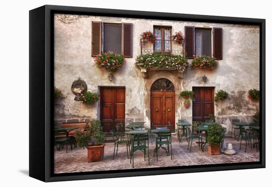 Italy, Tuscany, Pienza. Tables and chairs set up outside for outdoor dining in the town of Pienza.-Julie Eggers-Framed Premier Image Canvas