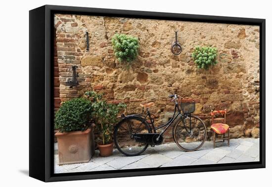 Italy, Tuscany, province of Siena, Chiusure. Hill town. Bicycle leans against stone wall.-Emily Wilson-Framed Premier Image Canvas