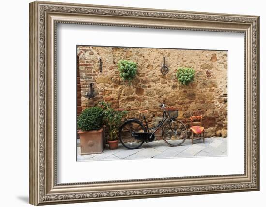 Italy, Tuscany, province of Siena, Chiusure. Hill town. Bicycle leans against stone wall.-Emily Wilson-Framed Photographic Print